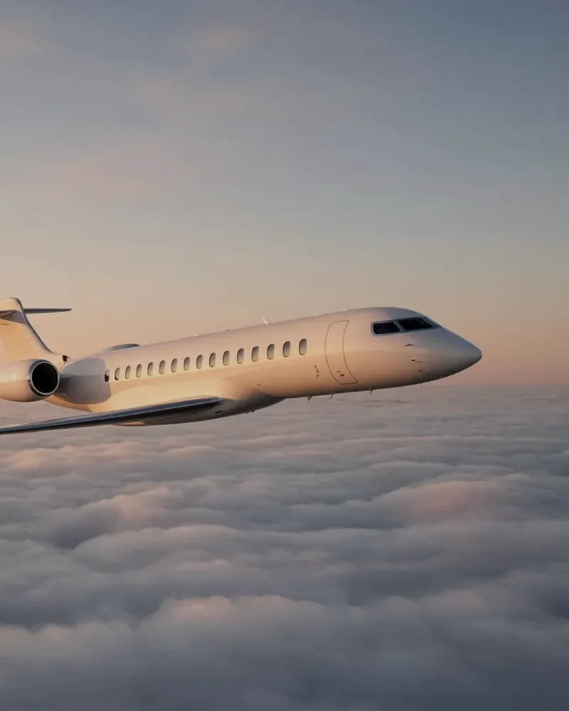 Business jet cruising above the clouds at sunset